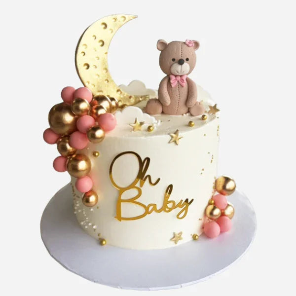 Baby shower cake with teddy bear, moon, and 'Oh Baby' text on a white background
