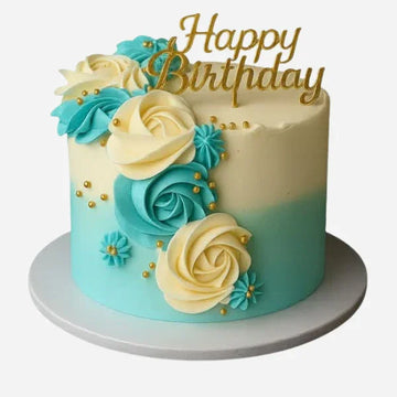 Birthday cake with blue and white flowers and 'Happy Birthday' topper on a white background