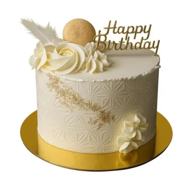 White birthday cake with gold accents and 'Happy Birthday' topper on a white background